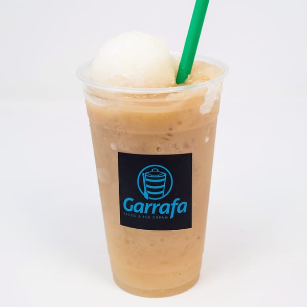 Garrafa's Mexican drink, a light brown slushy with a scoop of white ice cream and a green straw.